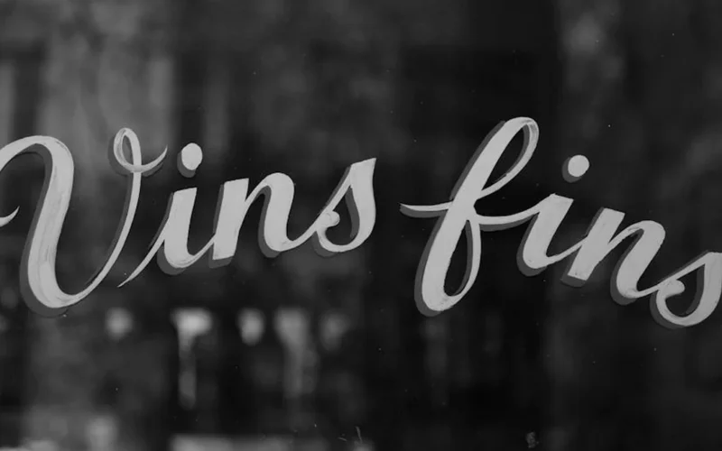 Natural wine bar featuring Spanish pintxos and rustic wooden decor under warm lighting.