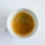 Vintage McDonald's coffee mug with dark roast beans and steam in a retro 1990s kitchen setting.