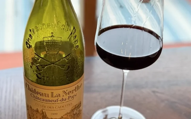 Vintage wine bottle uncorked in a rustic cellar with aged wood and leather details.