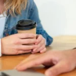Seven B Corp coffee brands collaborate around a sustainable coffee table with shared cup and natural light.
