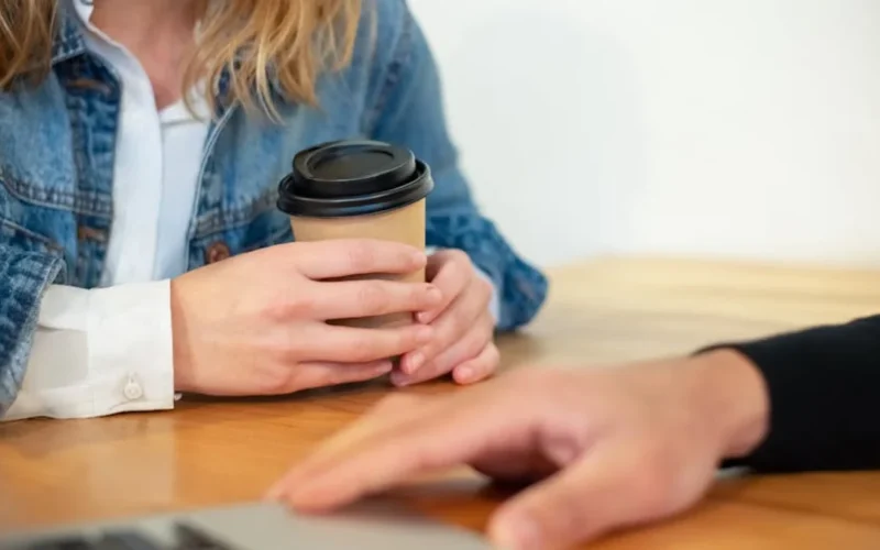 Seven B Corp coffee brands collaborate around a sustainable coffee table with shared cup and natural light.