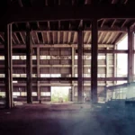 Vintage champagne bottle with RN18 code in a dusty warehouse setting