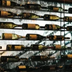 Elegant wine tasting room with wooden barrels and golden lighting.