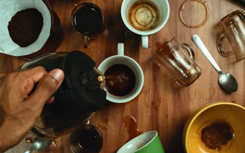 Coffee beans falling into a cup in an Italian café with warm lighting and wooden decor.