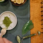 Traditional matcha bowl with tea utensils under warm lighting.