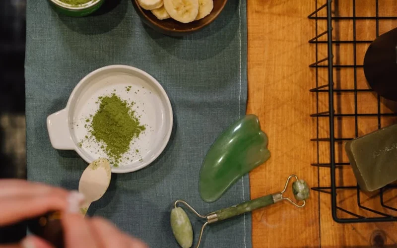 Traditional matcha bowl with tea utensils under warm lighting.