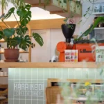 A steaming cup of North African coffee next to a spice jar in a traditional Moroccan café.