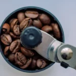A ribbon wrapped around a replacement o-ring on a coffee grinder, showing a tool-free repair technique.