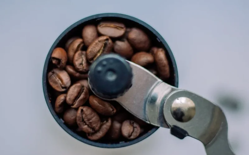 A ribbon wrapped around a replacement o-ring on a coffee grinder, showing a tool-free repair technique.