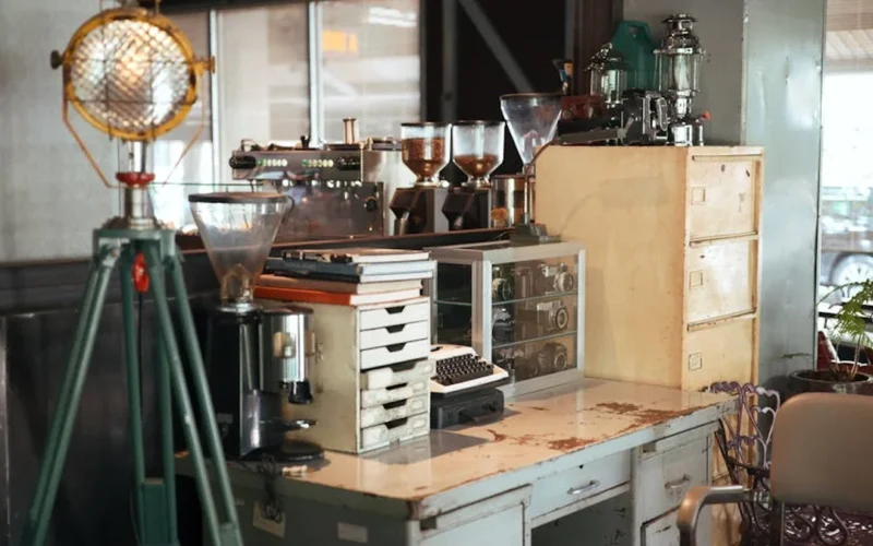 Brutalist styled coffee bar with espresso machine and steam rising from dark roast coffee.