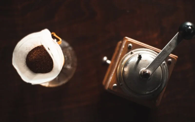 Kenyan AA coffee bean on pour over setup with steam and natural lighting.