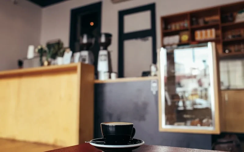 Vibrant Yemeni coffee shop with traditional brewing setup and gathered customers.