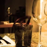 A chilled glass of pale pink rosé wine served with gourmet food in a restaurant.