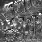 Deep red Cabernet Franc wine in a crystal glass on a dark slate surface.