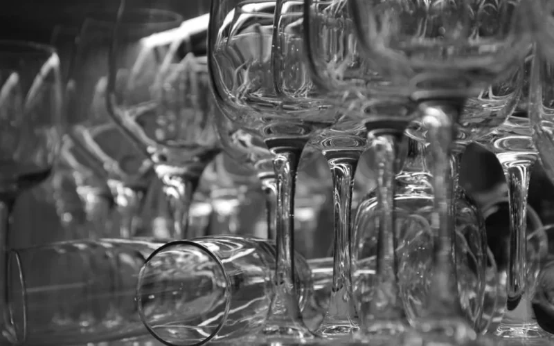 Deep red Cabernet Franc wine in a crystal glass on a dark slate surface.