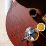 A comparison of a dark cup of coffee and bright green tea.