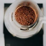Cold brew dripping from Hive Brew One into glass in minimalist kitchen setting.