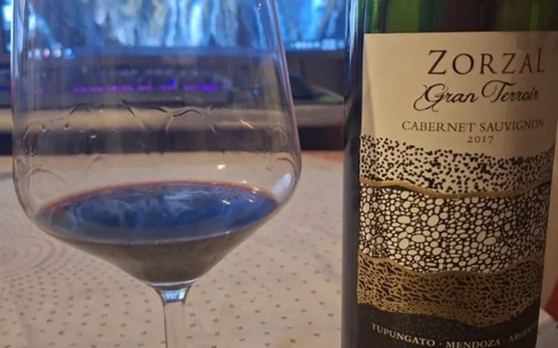 Close up of red wine being poured into a premium crystal tasting glass