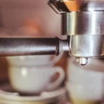 High-end coffee grinder grinding beans in modern kitchen setting with soft lighting and precision focus.