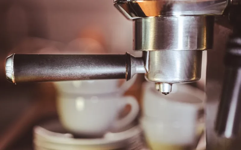 High-end coffee grinder grinding beans in modern kitchen setting with soft lighting and precision focus.