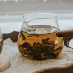 A glass carafe filled with dark Earl Grey cold brew tea on a kitchen counter.
