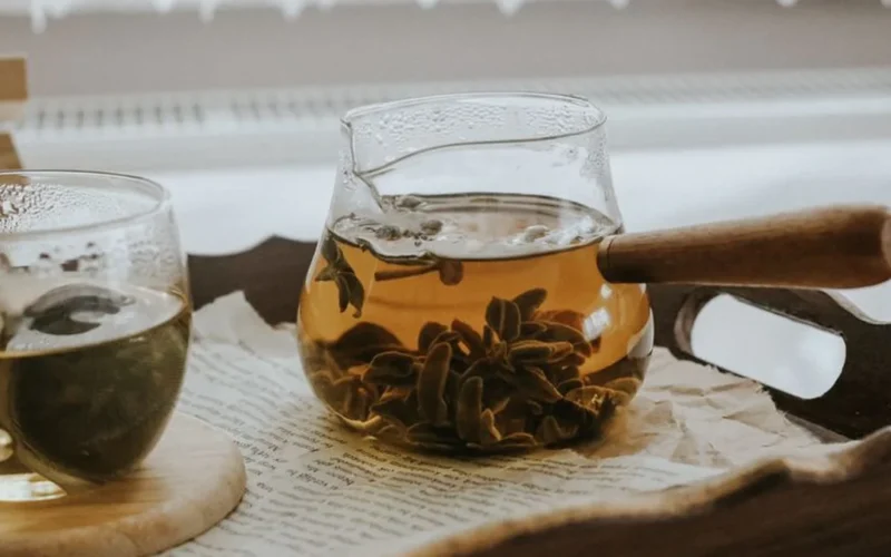 A glass carafe filled with dark Earl Grey cold brew tea on a kitchen counter.