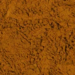 Macro view of different sized coffee particle layers inside a clear glass brewing vessel.