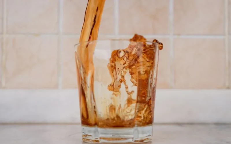 Refreshing ready-to-drink fruit infused iced tea in a glass bottle with ice.
