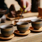 A tea ceremony in a rainforest with a choir performing, sunlight filtering through the canopy.