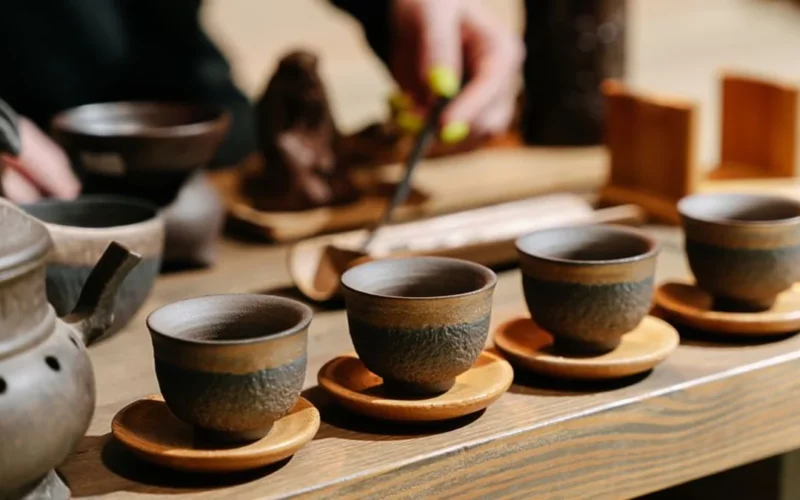A tea ceremony in a rainforest with a choir performing, sunlight filtering through the canopy.