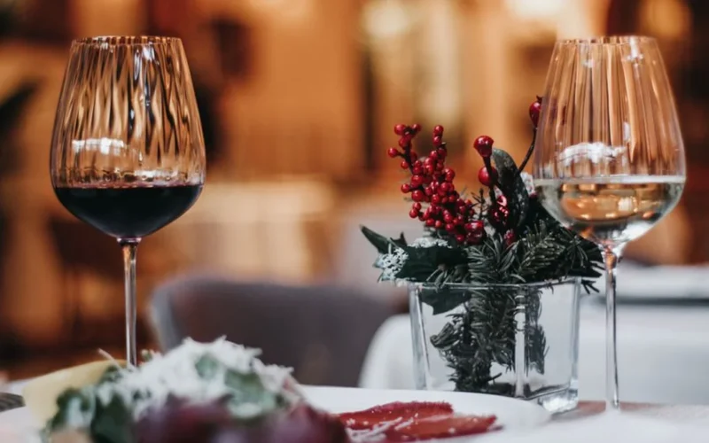 A glass of Alsatian white wine and Côtes du Rhône red wine paired with spicy food.