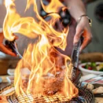 Professional server performing tableside carving service at a fine dining restaurant table.