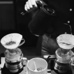 Close up of a Hario V60 NEO dripper on a glass carafe during coffee brewing.