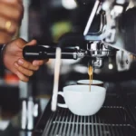Comparison of a traditional chrome E61 espresso machine and a modern black single boiler machine.
