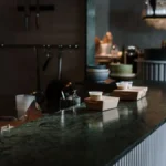 A glass of red wine on a marble bar in a sophisticated restaurant setting.