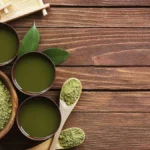 Close-up of premium hand-rolled kabuse sencha tea leaves in a ceramic dish.