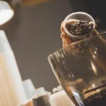 Person using an AeroPress to brew manual pour-over coffee in Mexico City.