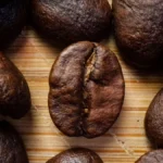 Dark roasted coffee beans paired with a digital representation of a biological protein molecule.