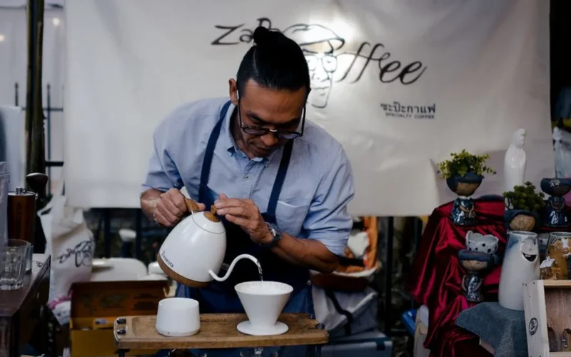 Pour over coffee being brewed with the Rocky Mountains in the background.