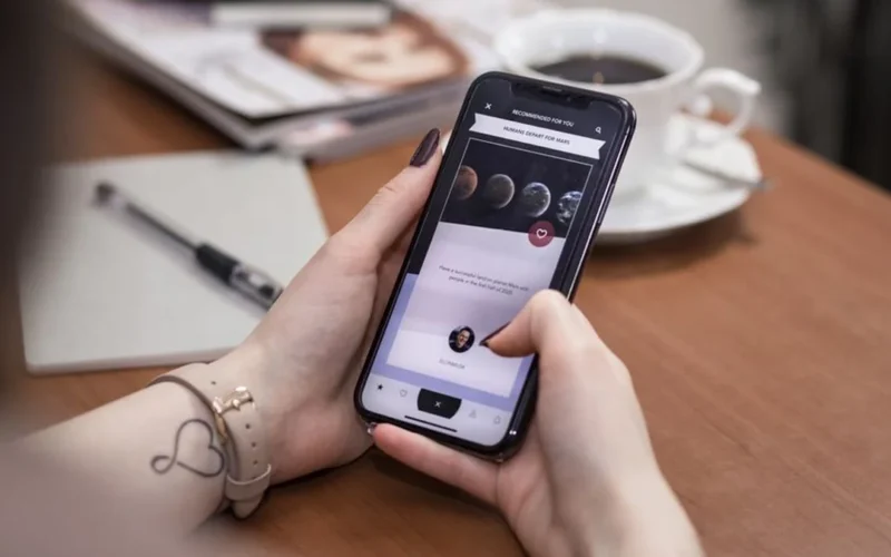 Person using a smartphone to scan a QR code on coffee bean packaging for blockchain transparency.