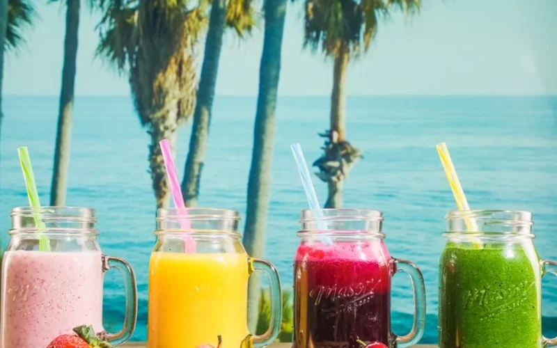 A collection of antioxidant rich drinks including coffee, hibiscus tea, and berry juice.