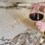A glass of red wine on a marble table in a luxury Napa Valley winery.