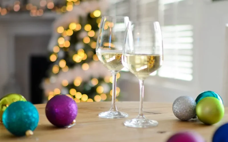 Pale golden Savagnin wine in a glass resting on textured grey stone.