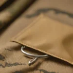 Tea sachet and MRE heater on camouflage fabric for paratrooper field logistics.