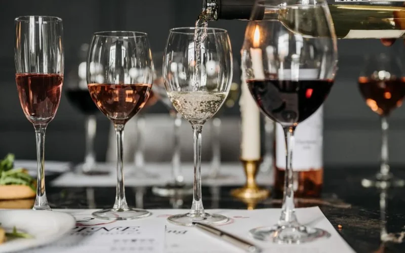Assorted white wine and sparkling wine glasses on a restaurant table in Matosinhos.