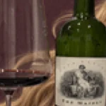 A glass of mature Napa Valley Cabernet Sauvignon beside an open wine bottle.
