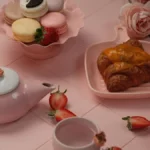 Overhead view of luxury afternoon tea with matcha scones and colorful pastries on marble.