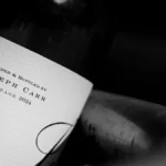 Macro close-up of alcohol percentage printed on a textured wine bottle label.