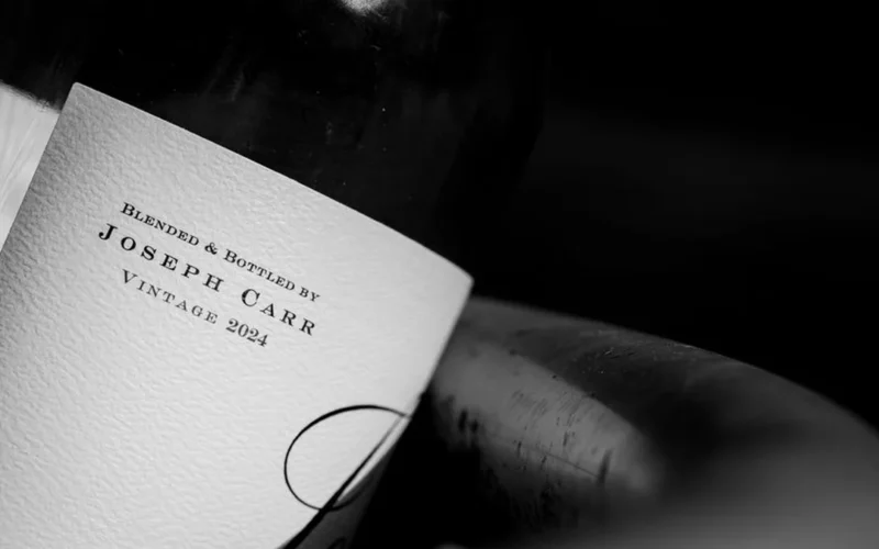 Macro close-up of alcohol percentage printed on a textured wine bottle label.
