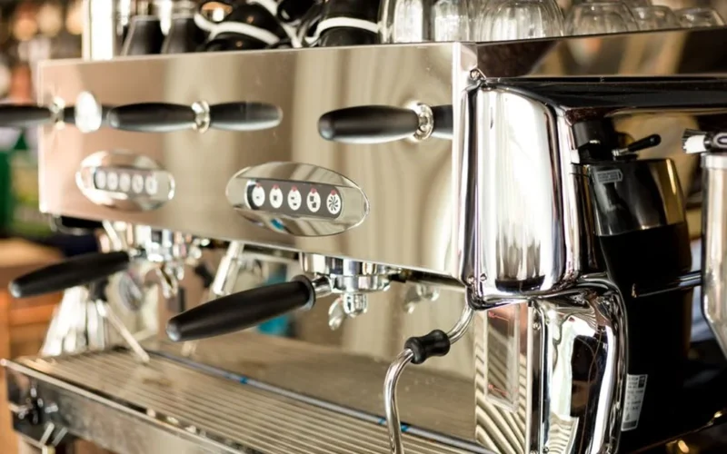 A stainless steel Breville Spiral Luxe automatic pour over coffee machine on a marble countertop.